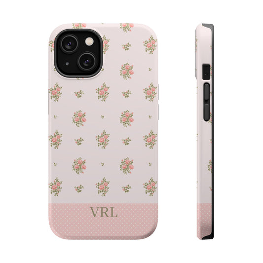 A light pink phone case with a delicate floral pattern and a solid polka-dot bottom section featuring the initials in light green. A side profile of the case is shown next to the back view on a plain white background.